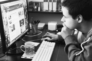 boy looking at computer screen